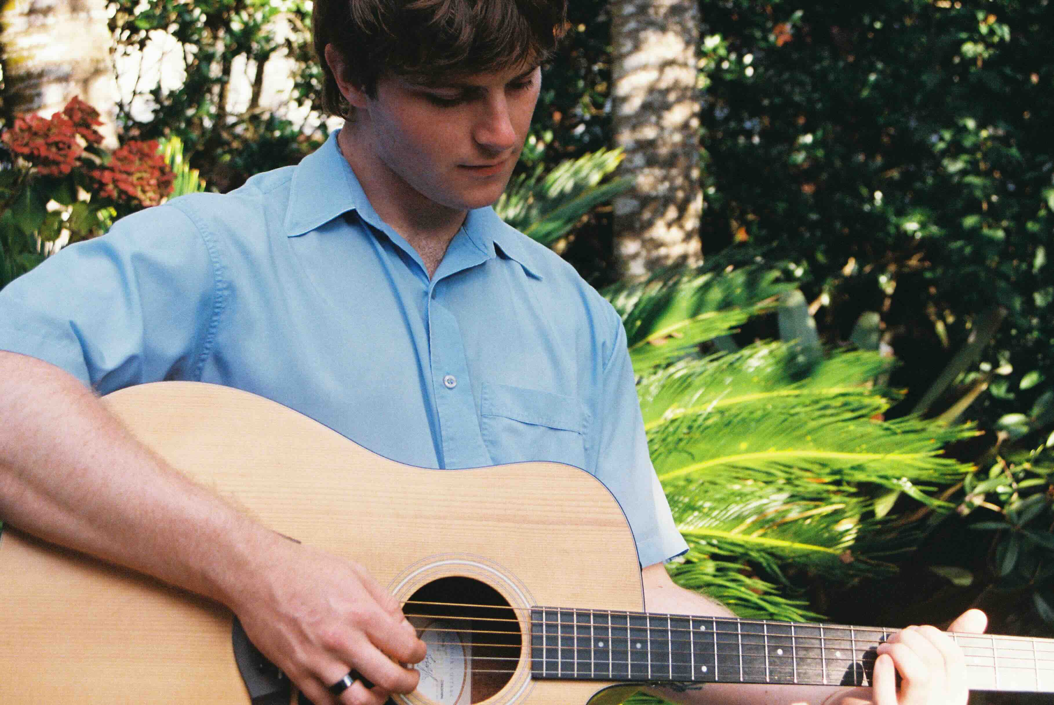 Student playing acoustic guitar