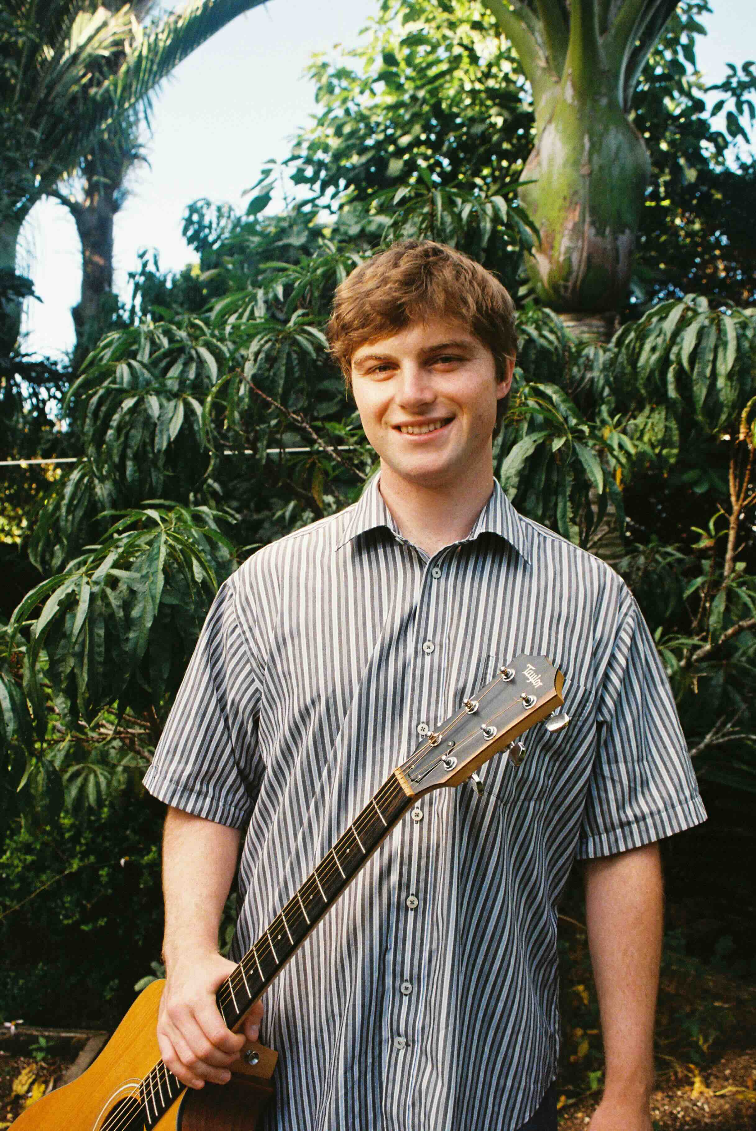 Jono Stewart holding an acoustic guitar